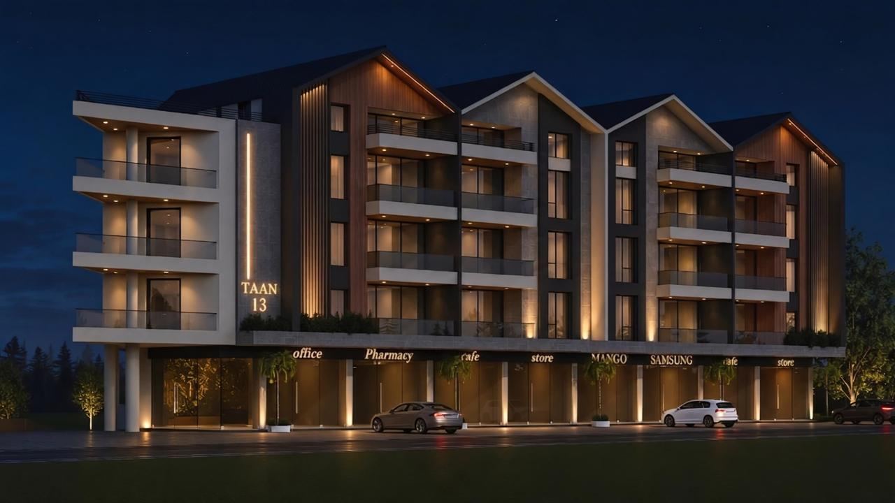 Full street elevation of TAAN 13 at night, ground-floor retail glowing beneath the apartments